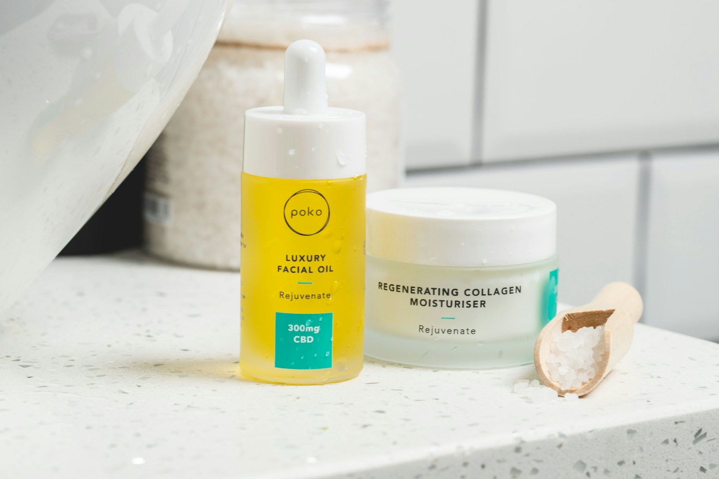Skincare products and bath salts on a bathroom countertop.